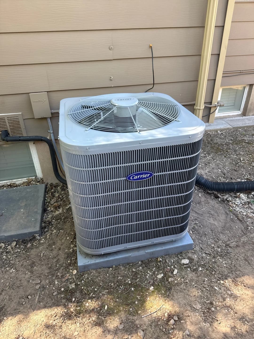 Carrier air conditioner installed beside a home