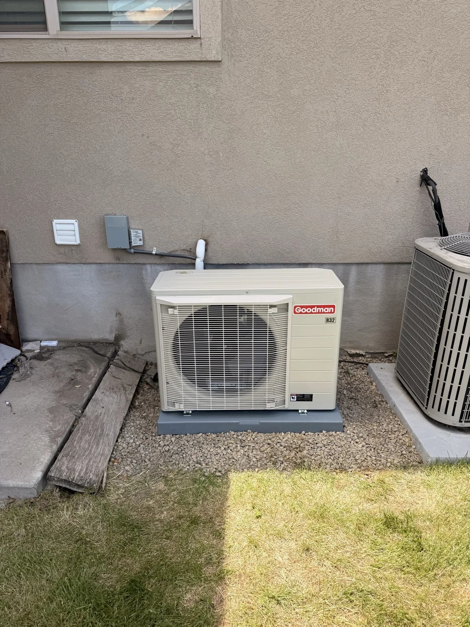 Side-discharge heat pump installed level on a pad by Citizen HVAC