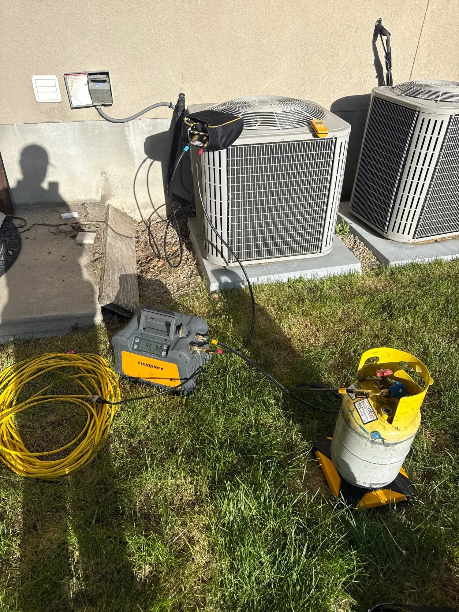 Citizen HVAC refrigerant recovery equipment hooked up to a condenser during a repair